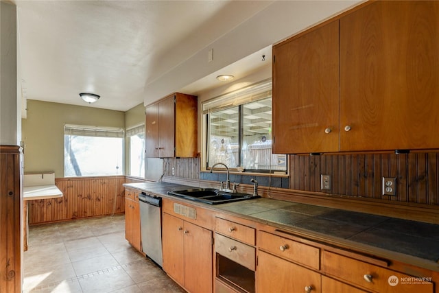 kitchen with stainless steel dishwasher, tile countertops, sink, and decorative backsplash