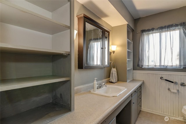 bathroom with tile patterned flooring, vanity, and toilet