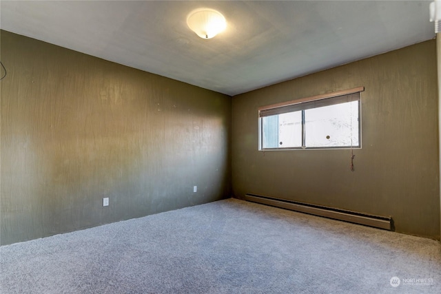 empty room featuring a baseboard radiator and carpet