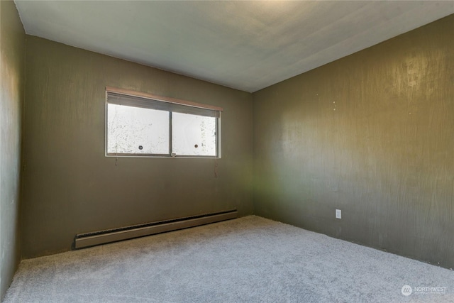 empty room with a baseboard radiator and carpet flooring