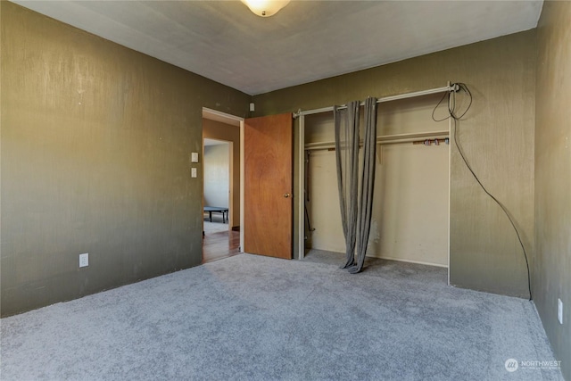 unfurnished bedroom featuring a closet and carpet