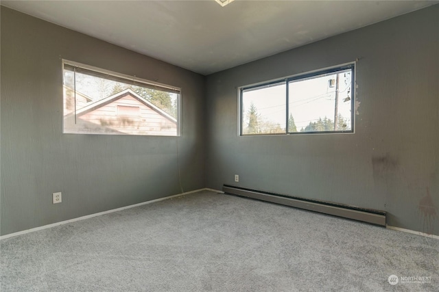 unfurnished room featuring a baseboard radiator and light carpet