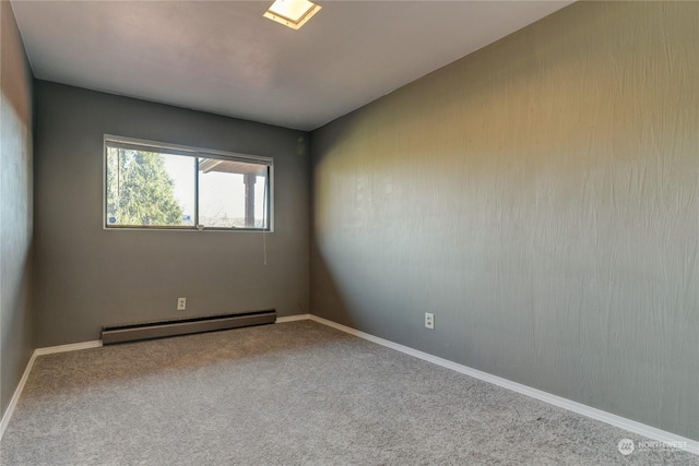 empty room featuring carpet and baseboard heating