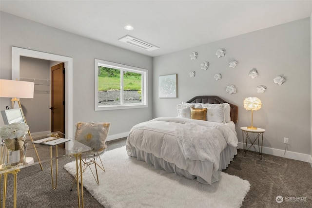 bedroom with dark colored carpet