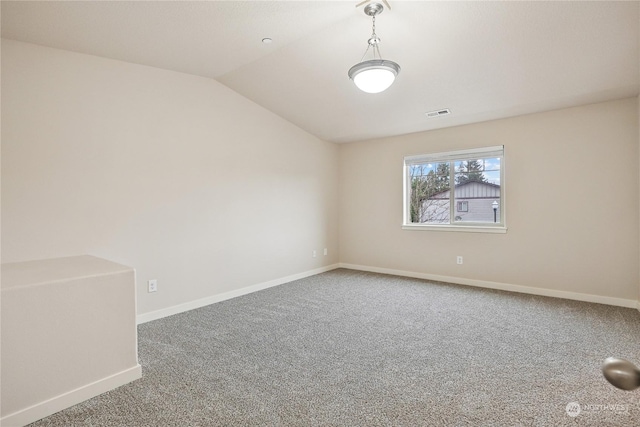 empty room featuring carpet flooring and lofted ceiling