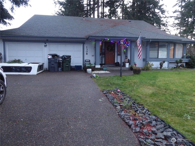 ranch-style house with a garage and a front lawn