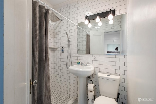 bathroom with toilet, curtained shower, and tile walls