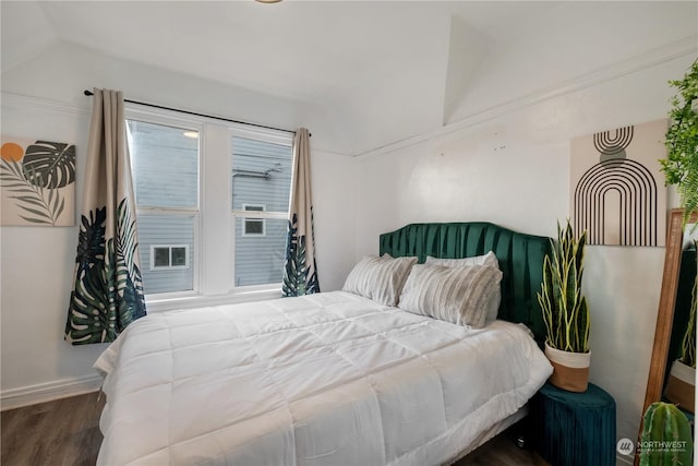 bedroom featuring dark wood-type flooring and vaulted ceiling