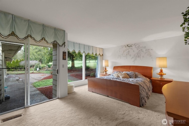 carpeted bedroom with access to exterior and visible vents