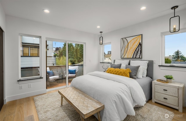 bedroom with light hardwood / wood-style floors and access to exterior