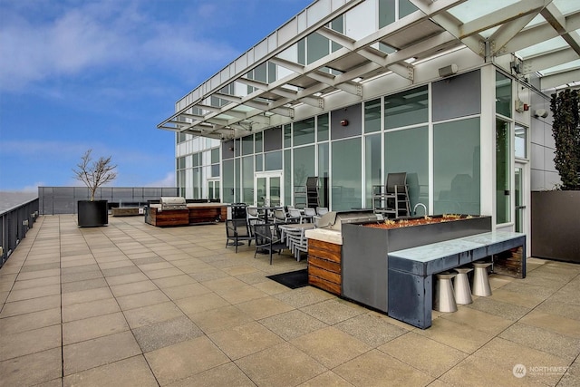 view of patio featuring exterior bar and a jacuzzi