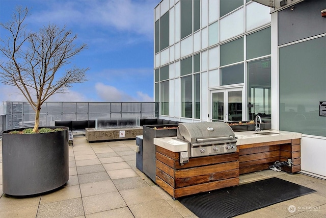 view of patio / terrace with exterior kitchen, sink, and area for grilling