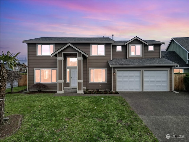 view of front of property featuring a lawn and a garage