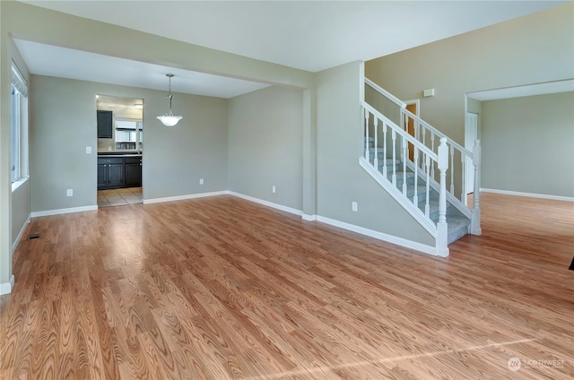 unfurnished living room with light hardwood / wood-style floors