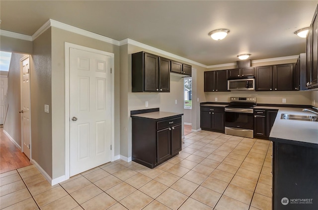 kitchen featuring crown molding, sink, dark brown cabinetry, and stainless steel appliances