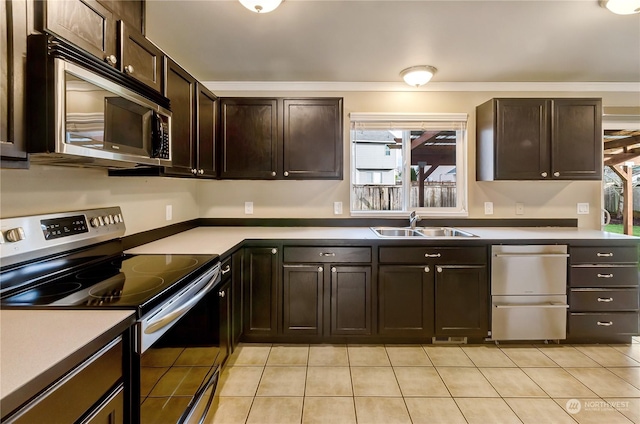 kitchen featuring sink, light tile patterned floors, a healthy amount of sunlight, and appliances with stainless steel finishes