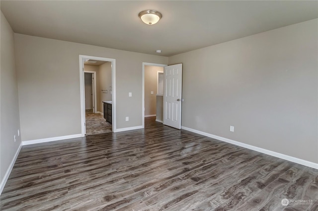 spare room with dark hardwood / wood-style floors