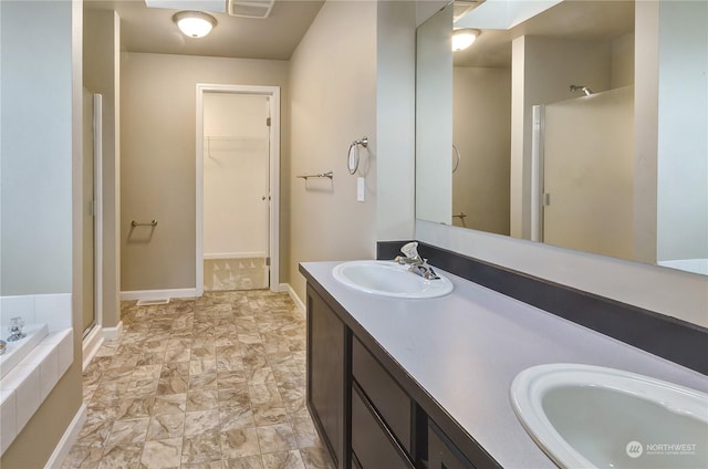 bathroom featuring shower with separate bathtub and vanity