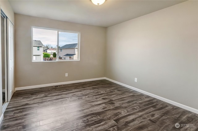 empty room featuring dark wood-type flooring