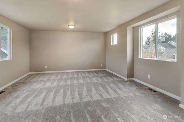 unfurnished room featuring light carpet