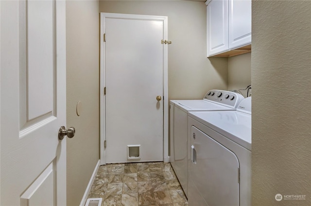 laundry area with cabinets and washing machine and dryer