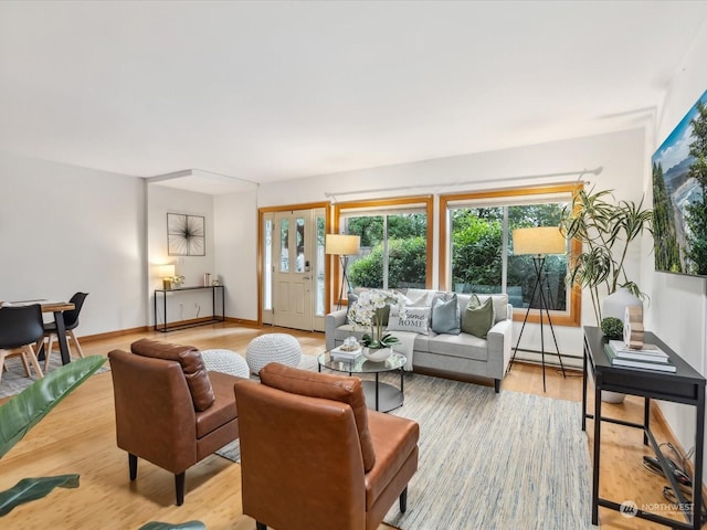 living room with hardwood / wood-style flooring and baseboard heating