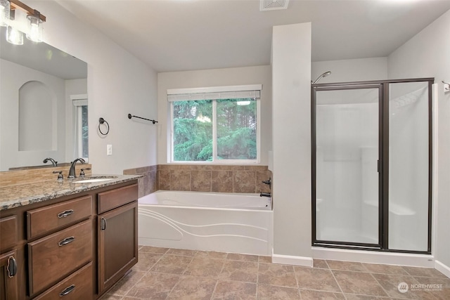 bathroom featuring separate shower and tub and vanity