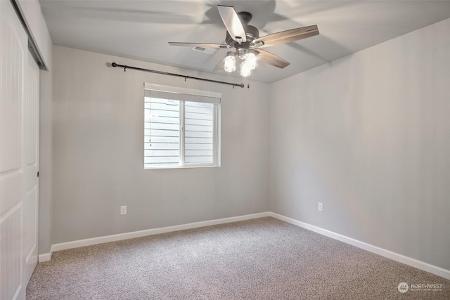 carpeted empty room with ceiling fan