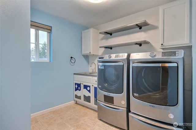 laundry room with light tile patterned flooring, cabinets, washer and dryer, and sink