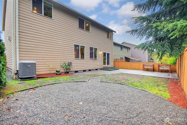 back of property featuring central air condition unit and a patio