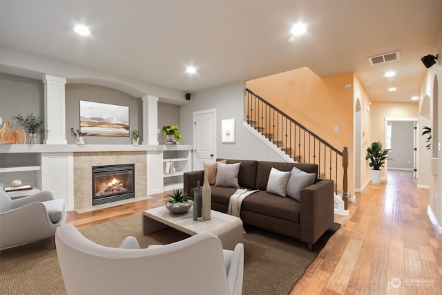 living room with light hardwood / wood-style floors and a fireplace