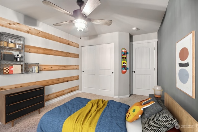 bedroom featuring ceiling fan, light colored carpet, and a closet