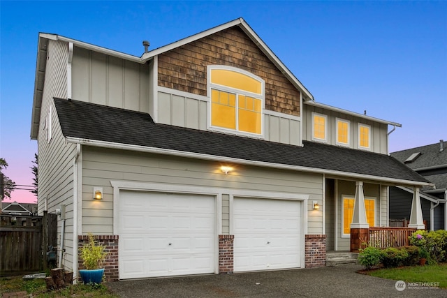 view of front of house featuring covered porch and a garage