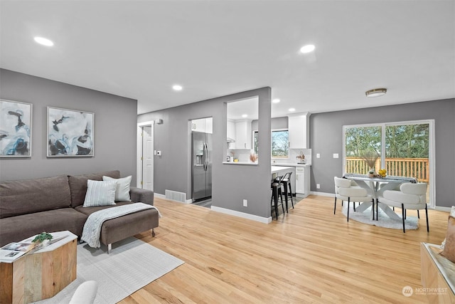 living room with light hardwood / wood-style flooring