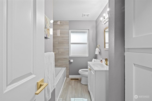 full bathroom featuring hardwood / wood-style flooring, vanity, toilet, and shower / bath combination