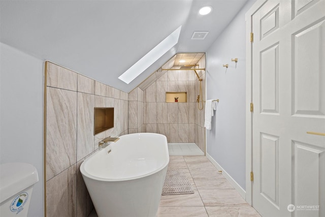 bathroom featuring vaulted ceiling with skylight, tile walls, and independent shower and bath