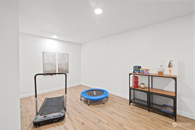 workout room with wood-type flooring