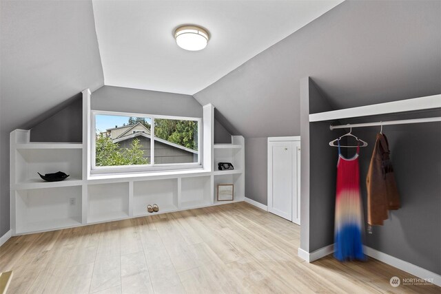 bonus room with light hardwood / wood-style flooring and lofted ceiling