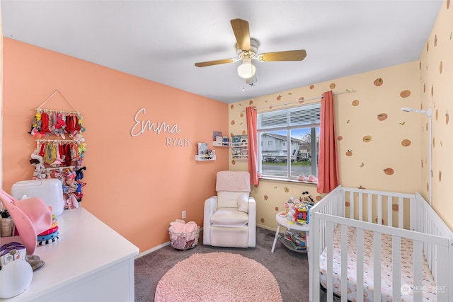 bedroom featuring carpet flooring, a nursery area, and ceiling fan