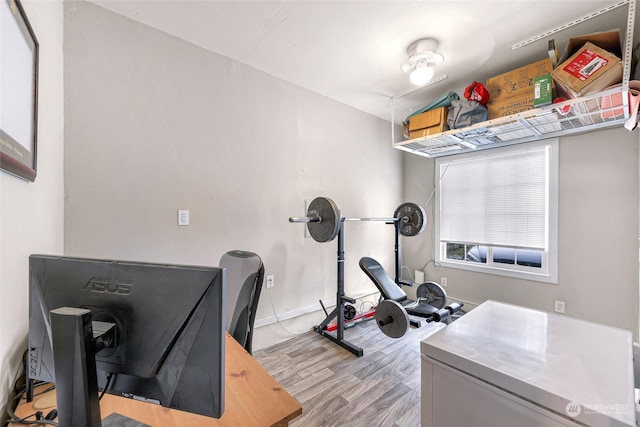 workout room with light hardwood / wood-style floors