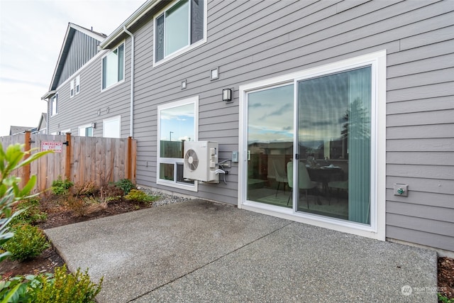 rear view of property featuring ac unit and a patio