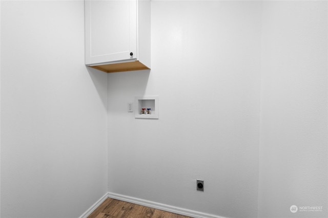 laundry area with cabinets, hookup for a washing machine, hardwood / wood-style flooring, and electric dryer hookup