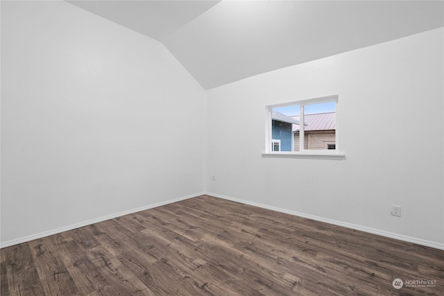 additional living space with dark hardwood / wood-style floors and lofted ceiling