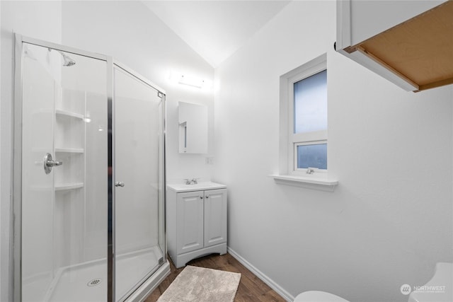 bathroom featuring hardwood / wood-style floors, vanity, an enclosed shower, and vaulted ceiling