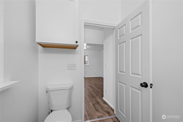 bathroom featuring hardwood / wood-style floors and toilet