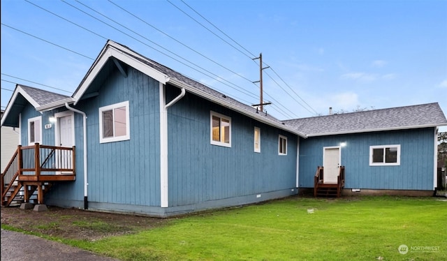 rear view of house featuring a lawn