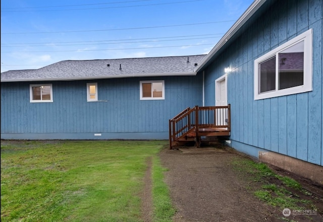 rear view of house featuring a lawn