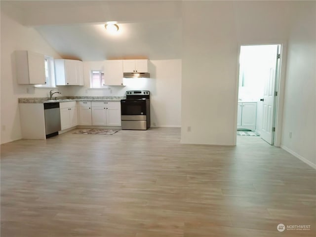 kitchen with appliances with stainless steel finishes, vaulted ceiling, sink, light hardwood / wood-style flooring, and white cabinets