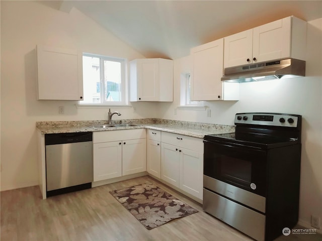 kitchen with lofted ceiling, sink, white cabinetry, and stainless steel appliances