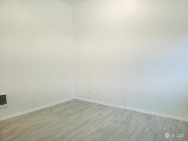 unfurnished room with light hardwood / wood-style flooring